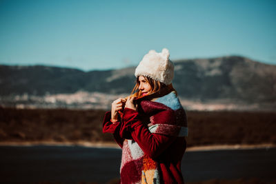 Midsection of woman standing on snow covered land