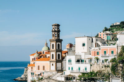 Old residential buildings on rocky coastline