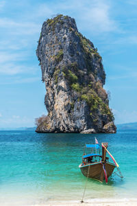 Scenic view of rock formation in sea against sky