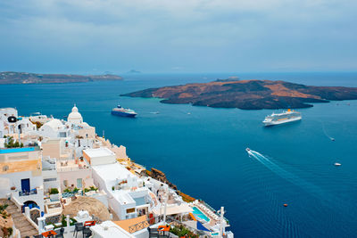 High angle view of townscape by sea against sky