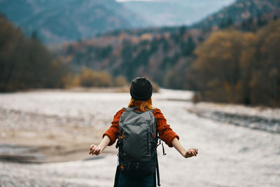 Rear view of man looking at waterfall