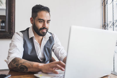 Handsome man dressed as executive working on the laptop