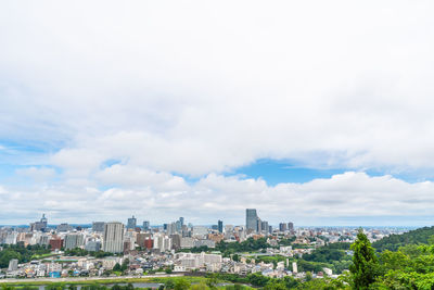 Panoramic view of buildings in city against sky