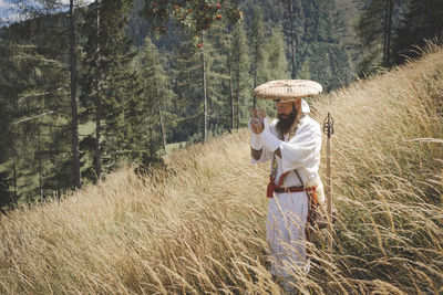 Woman standing by plants on land