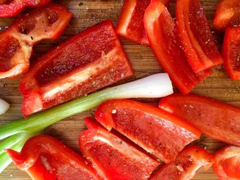 Close-up of red bell pepper and spring onion on cutting board