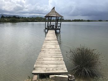 Pier over lake against sky
