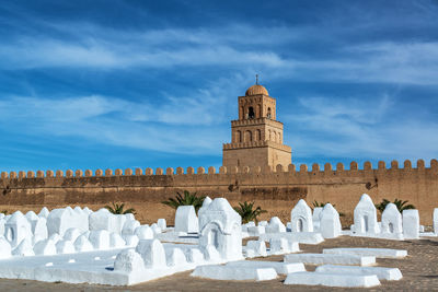 View of historical building against blue sky during sunny day