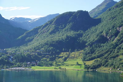 Scenic view of lake and mountains against sky