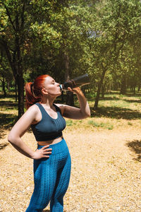 Woman drinking water in garden