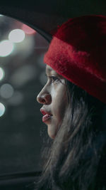 Close-up portrait of young woman looking away