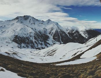 Scenic view of mountains against cloudy sky