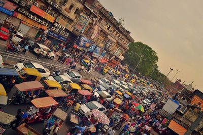 High angle view of people and vehicles on road in town