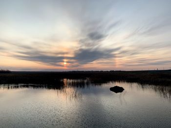 Scenic view of lake against sky during sunset