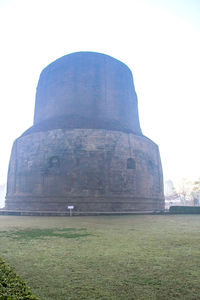 View of stone structure on field against clear sky