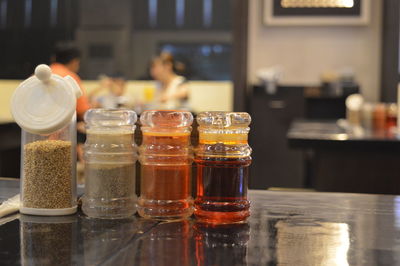 Close-up of glass bottles on table