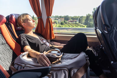 Beautiful woman sleeping in bus