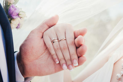 Close-up of couple with holding hands