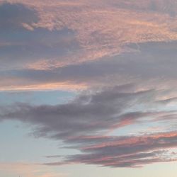 Low angle view of cloudy sky at sunset