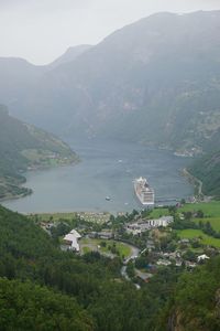 Scenic view of sea and buildings against mountains