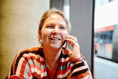 Close-up of mature woman talking on phone while sitting outdoors