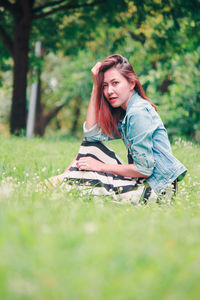 Young woman sitting on field