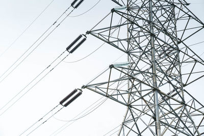 Close-up low angle view of cropped electricity pylon