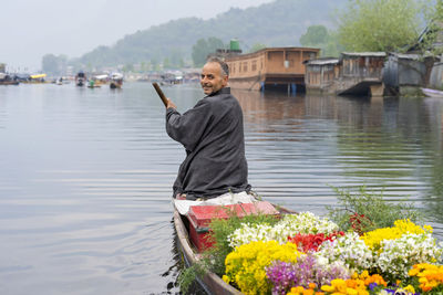 Full length of woman on boat at lake