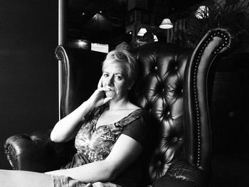 Portrait of mature woman sitting on chair