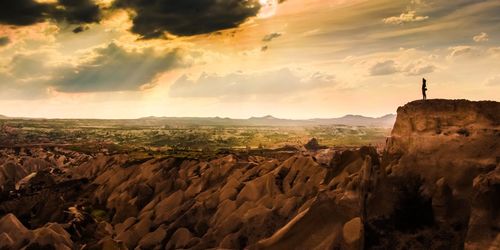 Scenic view of landscape against cloudy sky