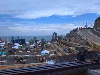 High angle view of buildings by sea against sky