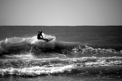 View of a silhouette man surfing in the sea