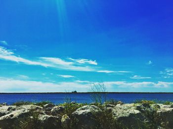 Scenic view of sea against blue sky