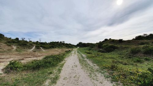 Dirt road along countryside landscape