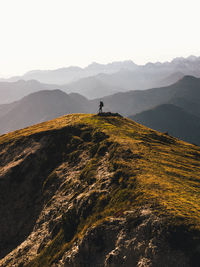 Man standing on mountain against sky