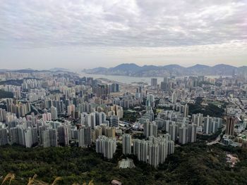 Aerial view of buildings in city against sky