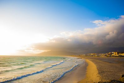 Scenic view of beach against sky during sunset