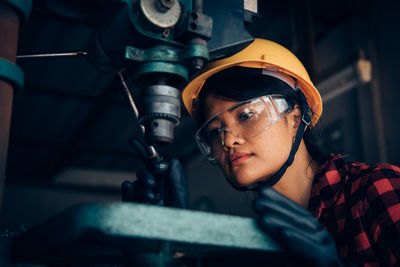 Close-up of woman working with equipment