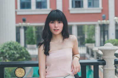 Portrait of young woman standing outdoors