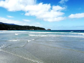 View of beach against cloudy sky