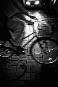 Low section of person walking on street in city