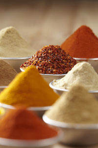 Close-up of various spices in containers on table