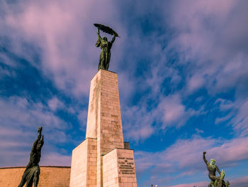 Low angle view of statue against cloudy sky