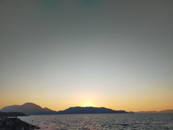 Scenic view of sea against clear sky during sunset