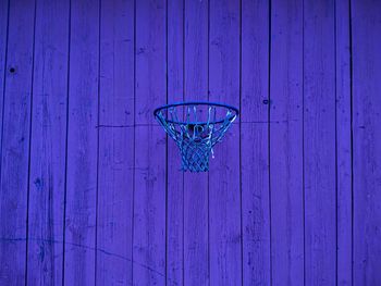 Basket ball hoop hanging from wooden wall