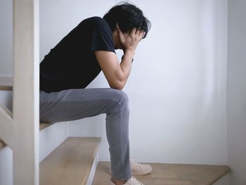 Young man sitting on steps