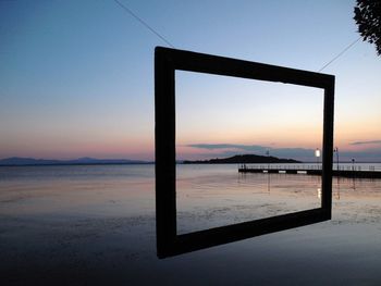 Scenic view of sea against clear sky during sunset