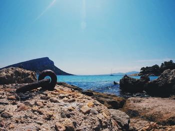 Scenic view of calm sea against clear blue sky