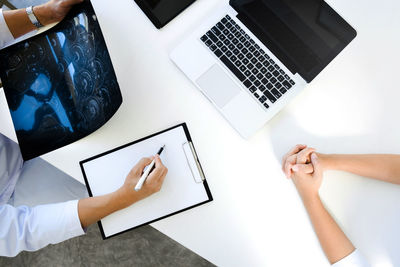 High angle view of woman using laptop on table