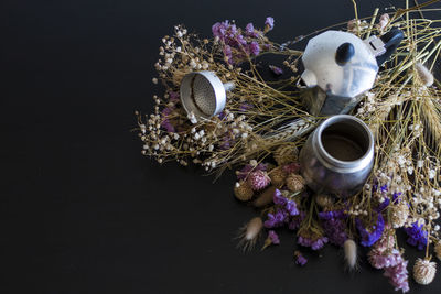 Close-up of purple flowers on table against black background