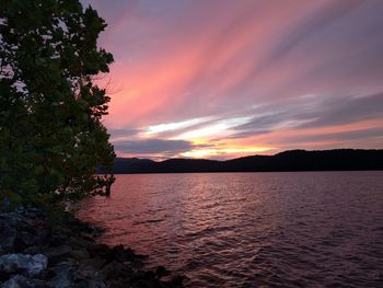 Scenic view of lake against orange sky